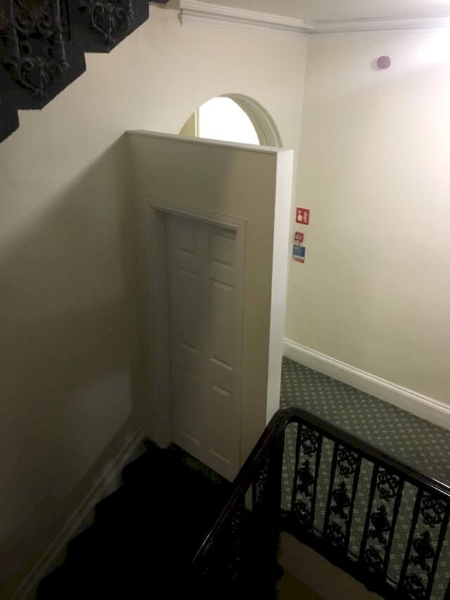 This weird door at the top of the stairs in a weird hotel