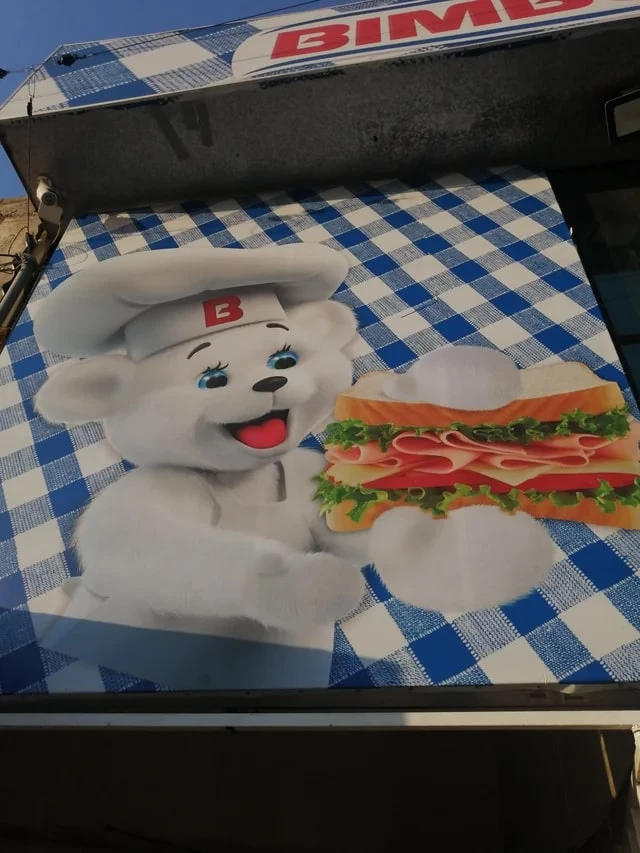 Bimbos Bear Holding A Sandwich With Three Hands
