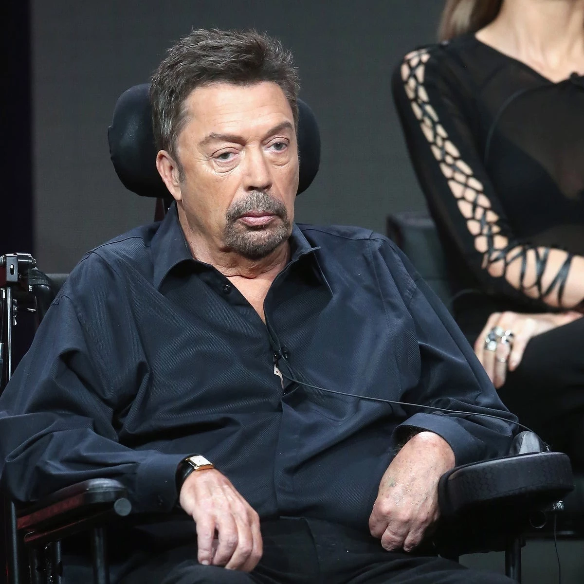 why is tim curry in a wheelchair