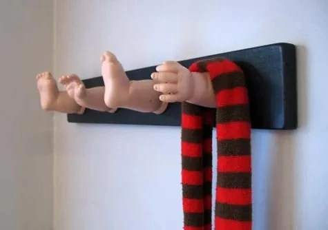 the hangers with eerie pictures of children's hands and feet