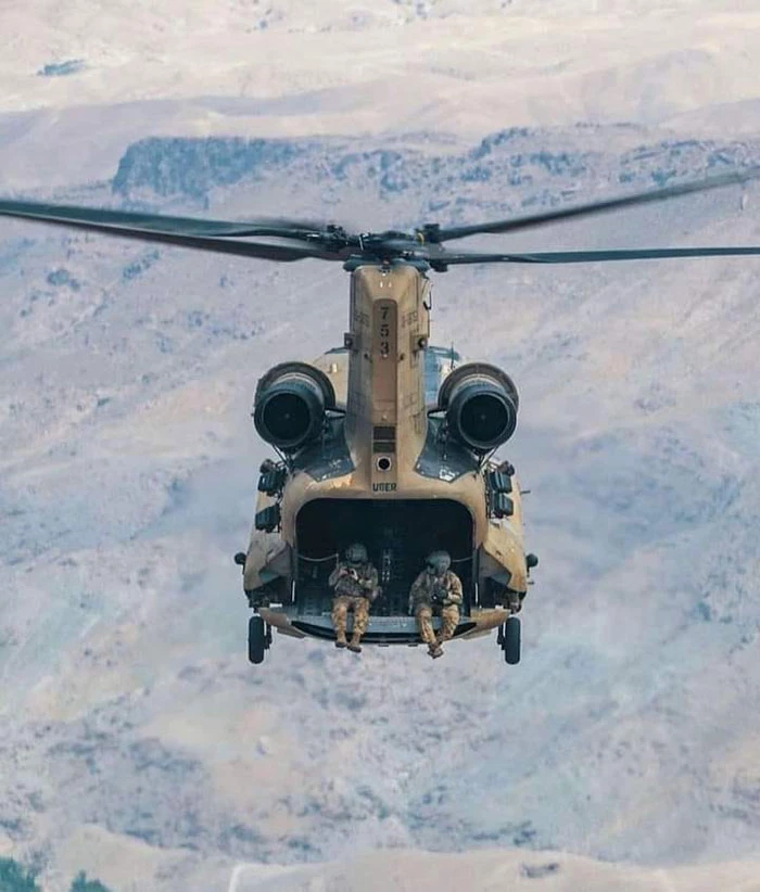 This Helicopter Looks Like It’s Going To Swallow Up The Two Soldiers