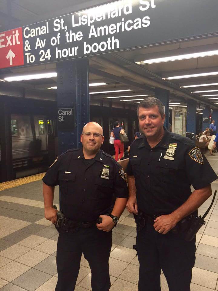 police saves a cat from subway tracks